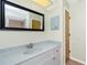 Bathroom featuring vanity with a framed mirror, and a tiled shower/tub combo at 10116 Melanie Ave, Englewood, FL 34224