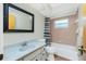 Bathroom featuring tub with shower, vanity with a mirror, and vinyl flooring at 10116 Melanie Ave, Englewood, FL 34224