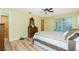 Spacious bedroom with ceiling fan, dresser, and views of the beautiful backyard at 10116 Melanie Ave, Englewood, FL 34224