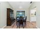 Dining room with wood-look floors, modern lighting fixture, and sliding doors to outdoor space at 10116 Melanie Ave, Englewood, FL 34224