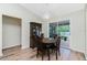 The dining area features wood-look floors, a china cabinet, and a view of the screened-in lanai at 10116 Melanie Ave, Englewood, FL 34224
