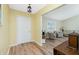 Welcoming entryway featuring wood-look flooring and views into the light and airy living room at 10116 Melanie Ave, Englewood, FL 34224