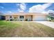 Charming single-story home featuring a well-manicured front yard and attached two car garage at 10116 Melanie Ave, Englewood, FL 34224