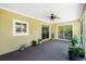 Enclosed lanai features neutral decor with views to the backyard, ceiling fan and sliding doors at 10116 Melanie Ave, Englewood, FL 34224