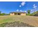 Spacious home featuring a well-maintained lawn and access to the backyard through sliding glass doors at 10242 Hallendale Dr, Port Charlotte, FL 33981