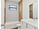 This modern bathroom features decorative wall tile, a soaking tub, and coordinated fixtures at 10242 Hallendale Dr, Port Charlotte, FL 33981