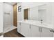 Modern bathroom features a double sink vanity and a walk-in shower with decorative tile at 10242 Hallendale Dr, Port Charlotte, FL 33981