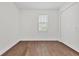 This bedroom features wood-style floors, a closet, and natural light from the window at 10242 Hallendale Dr, Port Charlotte, FL 33981
