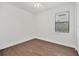 Empty bedroom with tile floors, a window, and a door, creating a clean and simple space at 10242 Hallendale Dr, Port Charlotte, FL 33981