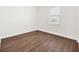 This is an empty bedroom featuring wood-style flooring with great natural light from the window at 10242 Hallendale Dr, Port Charlotte, FL 33981