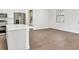 Open floor plan showcasing tile floors and access to the kitchen and bathroom at 10242 Hallendale Dr, Port Charlotte, FL 33981