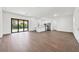 Large living area merges seamlessly with the kitchen area featuring dark tiled floors throughout at 10242 Hallendale Dr, Port Charlotte, FL 33981