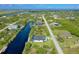 Scenic aerial view of a neighborhood with a waterfront home along a canal at 10454 Atenia St, Port Charlotte, FL 33981