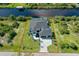 Aerial view of a beautiful home with property line in red showcasing the well-manicured lawn and waterfront access at 10454 Atenia St, Port Charlotte, FL 33981