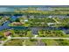 Aerial view of a waterfront home surrounded by lush landscaping and serene waterways at 10454 Atenia St, Port Charlotte, FL 33981