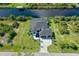 Aerial view of a beautiful home showcasing the well-manicured lawn and waterfront access at 10454 Atenia St, Port Charlotte, FL 33981