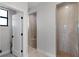 Modern bathroom featuring tiled walk-in showers with glass doors and pebble flooring at 10454 Atenia St, Port Charlotte, FL 33981