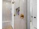 Luxurious bathroom with tiled walk-in shower, built-in shelf, and gold fixtures at 10454 Atenia St, Port Charlotte, FL 33981