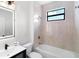 Modern bathroom featuring tiled shower over tub with bronze fixtures and vanity sink at 10454 Atenia St, Port Charlotte, FL 33981