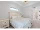 Calm bedroom with a white, full bed, wood floors, and minimalist style at 10454 Atenia St, Port Charlotte, FL 33981
