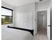 Bright bedroom with a black frame bed, closet with double doors, and large window at 10454 Atenia St, Port Charlotte, FL 33981