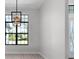 Dining room with a modern chandelier and large windows providing plenty of light at 10454 Atenia St, Port Charlotte, FL 33981