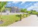 A new private dock, framed by palm trees and lush greenery, providing direct access to the waterfront at 10454 Atenia St, Port Charlotte, FL 33981