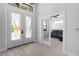 Bright foyer with glass double doors and a view into the living area at 10454 Atenia St, Port Charlotte, FL 33981