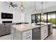 Marble island in a modern kitchen with stainless steel appliances and sleek pendant lighting at 10454 Atenia St, Port Charlotte, FL 33981