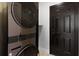Modern, stacked washer and dryer inside the house near a door at 10454 Atenia St, Port Charlotte, FL 33981