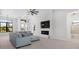 Bright open-concept living room with a fireplace, tv, and access to the bathroom at 10454 Atenia St, Port Charlotte, FL 33981