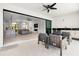 An elegant outdoor living area flowing into the living room, featuring a modern kitchen and stylish furniture at 10454 Atenia St, Port Charlotte, FL 33981