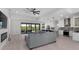 Spacious living room open to kitchen featuring modern gray finishes and an outdoor view at 10454 Atenia St, Port Charlotte, FL 33981