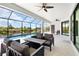 Relaxing outdoor patio with comfortable seating and waterfront views, offering a seamless blend of indoor-outdoor living at 10454 Atenia St, Port Charlotte, FL 33981