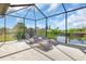 Relaxing outdoor patio with comfortable lounge chairs overlooking a tranquil canal at 10454 Atenia St, Port Charlotte, FL 33981