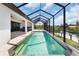 Stunning screened pool with waterfront views, perfect for relaxing and entertaining in luxurious outdoor living at 10454 Atenia St, Port Charlotte, FL 33981