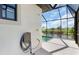 Outdoor shower beside a screened-in lanai and pool overlooking the canal at 10454 Atenia St, Port Charlotte, FL 33981