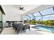 Inviting outdoor area with pool, bar, and seating, perfect for entertaining and enjoying the serene waterfront views at 10454 Atenia St, Port Charlotte, FL 33981