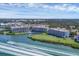 Aerial view of resort condos on waterfront with docks and boat; green lawns and wooded views at 11100 Hacienda Del Mar Blvd # G-304, Placida, FL 33946