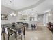 Dining area with a modern table, seating for six, and an open view into the kitchen at 11100 Hacienda Del Mar Blvd # G-304, Placida, FL 33946