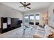 Inviting living room featuring a ceiling fan, access to the balcony, and stylish decor at 11100 Hacienda Del Mar Blvd # G-304, Placida, FL 33946