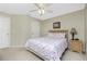 Bedroom featuring a bed with floral patterned comforter, ceiling fan, and neutral walls at 1247 Nora Ln, North Port, FL 34286