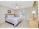 Bedroom featuring a bed with a floral patterned comforter and a light wood dresser at 1247 Nora Ln, North Port, FL 34286