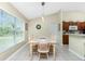 Cozy dining area next to the kitchen, illuminated by a modern pendant light at 1247 Nora Ln, North Port, FL 34286