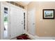 Bright entryway with white doors, side windows, and a decorative rug at 1247 Nora Ln, North Port, FL 34286