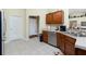Spacious kitchen featuring stainless steel appliances, wood cabinets and an exterior door nearby at 1247 Nora Ln, North Port, FL 34286