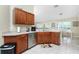 Bright kitchen boasts wood cabinets, stainless steel appliances, and an open dining area at 1247 Nora Ln, North Port, FL 34286