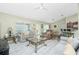 Inviting living room with a ceiling fan and bar seating at the counter at 1247 Nora Ln, North Port, FL 34286