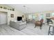 Open-concept living room with stylish furniture and a vaulted ceiling at 1247 Nora Ln, North Port, FL 34286