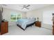 Bright main bedroom featuring a ceiling fan, neutral walls, and a large window at 1247 Nora Ln, North Port, FL 34286